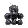 A set of seven artificial black pumpkins for fall and Halloween decoration.