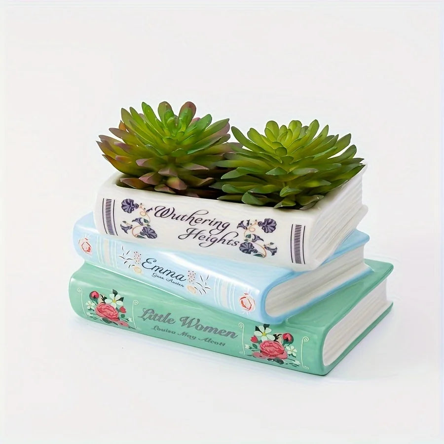 Une pile de trois livres en céramique en forme de vase, avec des têtes de succulentes vertes et des motifs floraux.