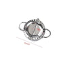 Stainless steel dumpling maker with a crimped edge shown from above.