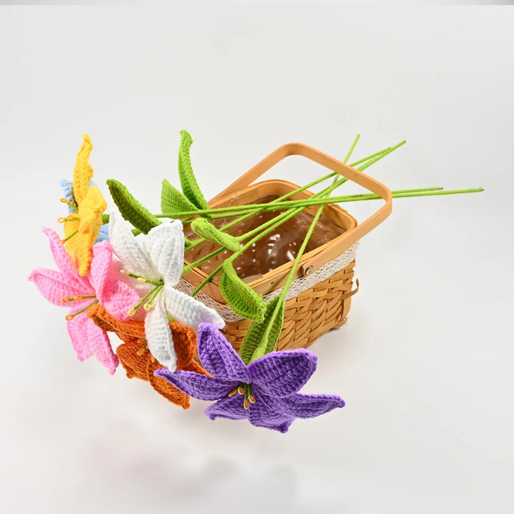 Hand-crocheted artificial lily bouquet featuring pink, white, and purple flowers with green stems in a woven basket