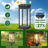 A black retro solar pathway light with an illuminated glass bulb, showing automatic charging and lighting features.
