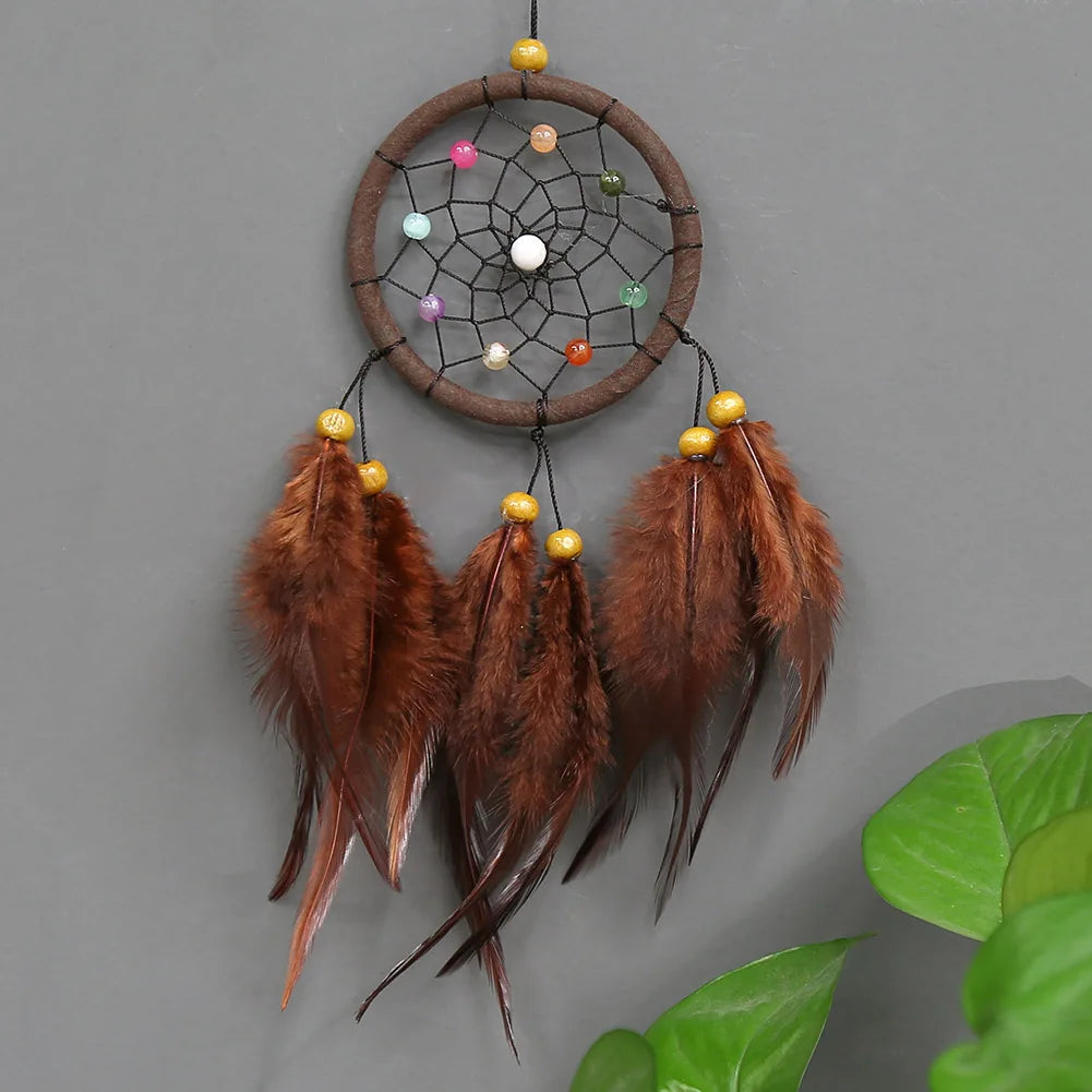 Handmade boho feather dream catcher wall decor featuring brown feathers and a circular woven hoop