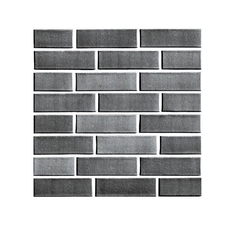 A rectangular pattern of dark gray 3D brick wall stickers.