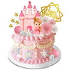 A pink princess castle cake topper set featuring a castle, a crown, and a gold birthday banner.