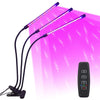 A purple LED plant grow light with multiple flexible arms and a remote control is shown against a bright pink background.
