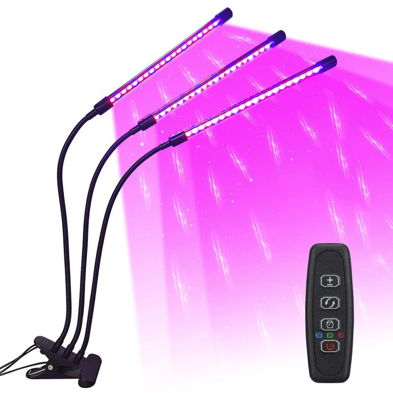 A purple LED plant grow light with multiple flexible arms and a remote control is shown against a bright pink background.