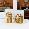 A set of golden silicone candle molds shaped like a mosque dome and a rectangular box, displayed on a white surface.