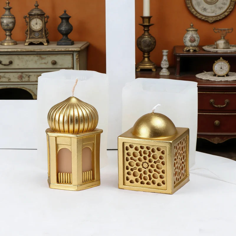 A set of golden silicone candle molds shaped like a mosque dome and a rectangular box, displayed on a white surface.