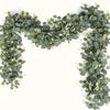 A horizontal garland of silvery-green eucalyptus leaves and small white flowers forming a decorative arch.