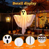 A white ghost decoration with flowing fabric is displayed next to a lantern and Halloween pumpkins.