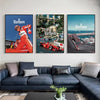 Three framed canvas art prints featuring Marlboro and Ferrari racing themes displayed on a wall above a dark sofa.