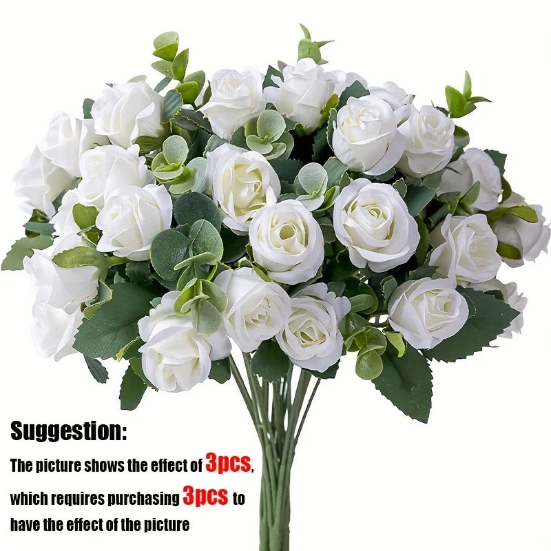 A bouquet of white silk roses and green eucalyptus leaves for wedding or home decor