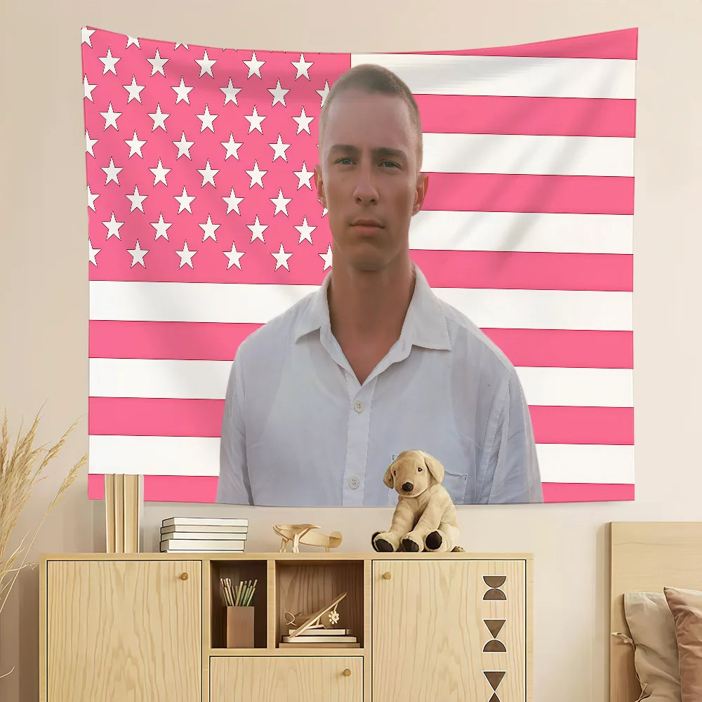 A white shirt is displayed in front of a wall tapestry featuring a pink and white American flag design.