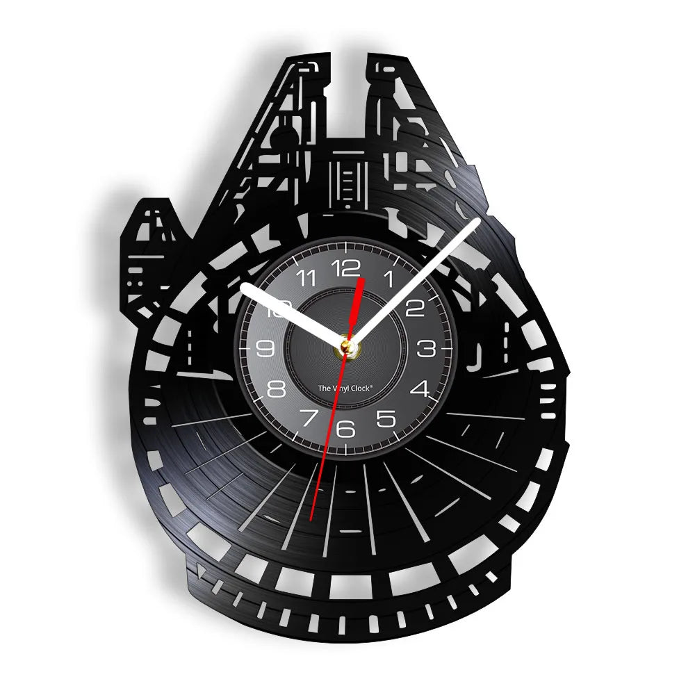 A black wall clock shaped like a vinyl record featuring a detailed design and Roman numerals.