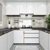 Modern kitchen cabinet and countertop featuring white cabinets, dark stone countertops, and stainless steel appliances.