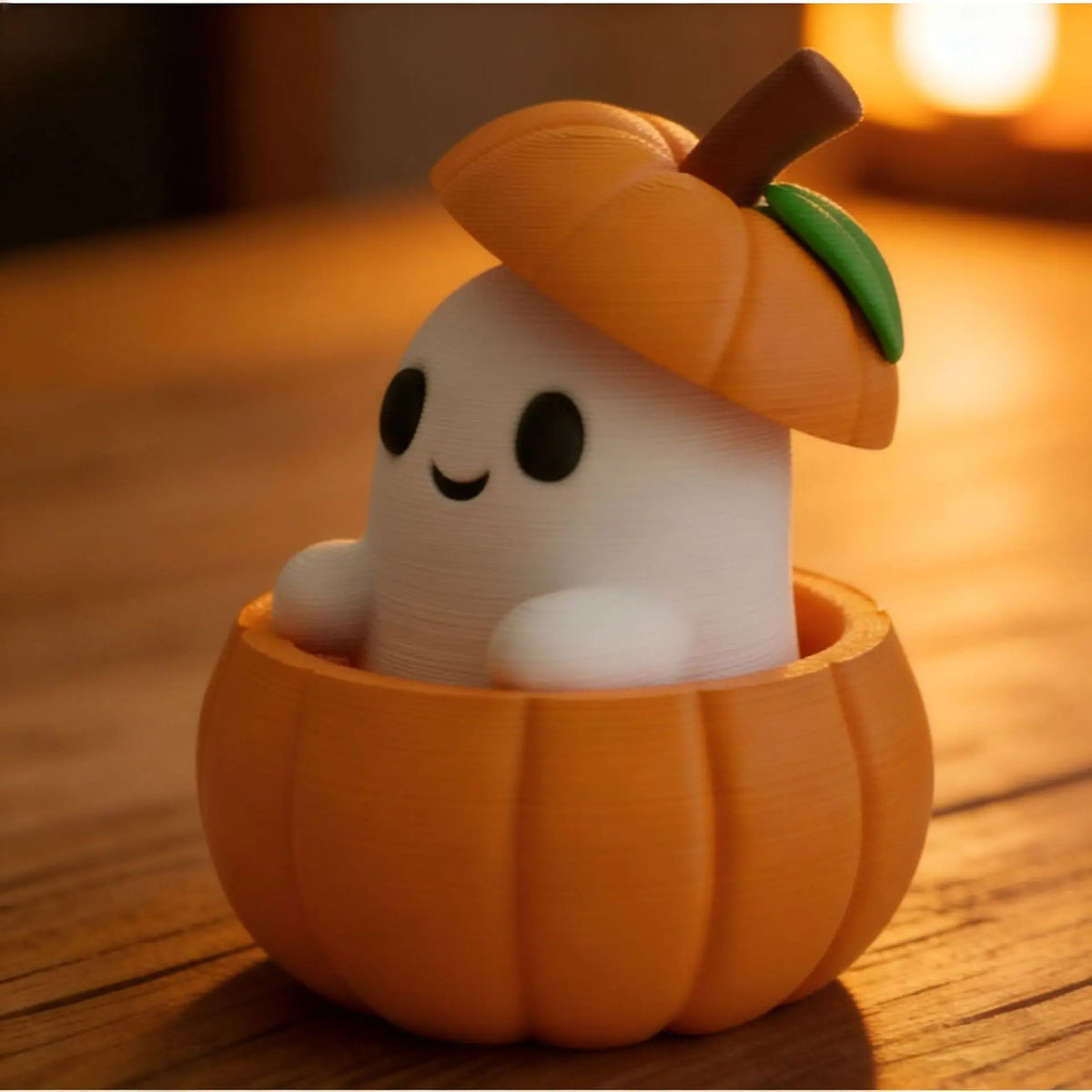 A white elf-like figure is placed inside an orange pumpkin shell, used as a desktop Halloween decor.