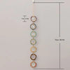 A set of nine crystal suncatchers hanging vertically against a light background.