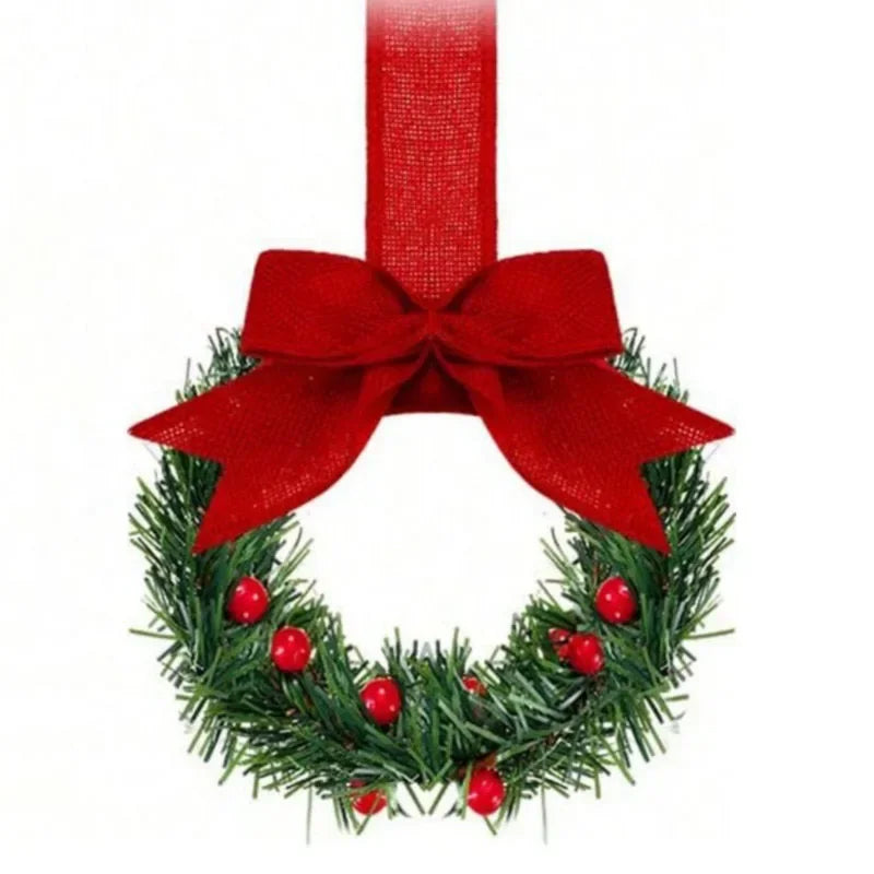 Set of four mini Christmas wreaths decorated with green foliage, red berries, and a red ribbon bow.
