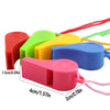 A collection of colorful plastic whistles in red, green, yellow, and blue attached to lanyards.