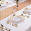 Elegant gold rim plastic dinner and dessert plate set displayed on a white tablecloth with gold confetti runner.