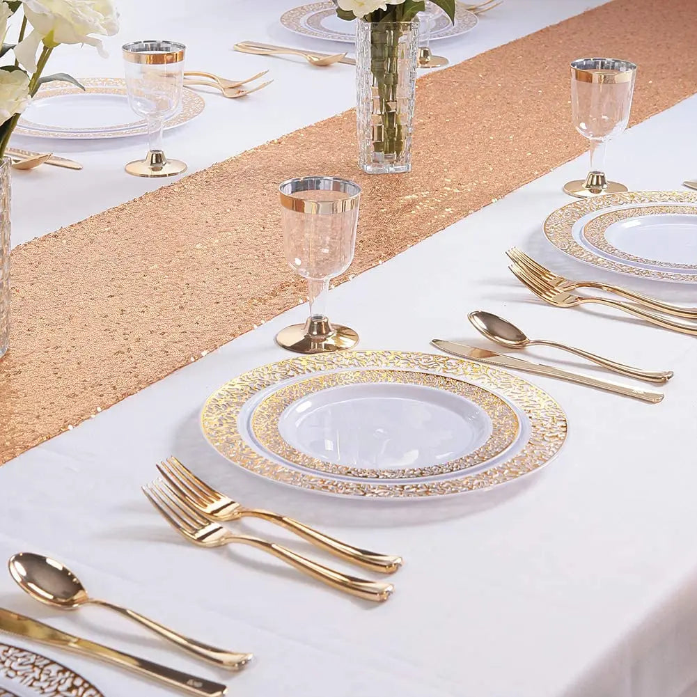 Elegant gold rim plastic dinner and dessert plate set displayed on a white tablecloth with gold confetti runner.