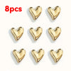 A set of eight gold heart-shaped fridge magnets.