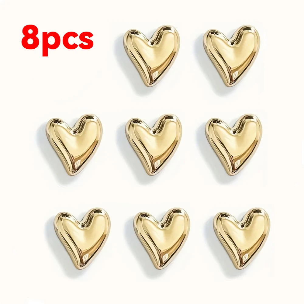 A set of eight gold heart-shaped fridge magnets.