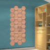 A vertical display of 12 self-adhesive hexagon mirror wall decor stickers in a light wood tone against a teal wall.