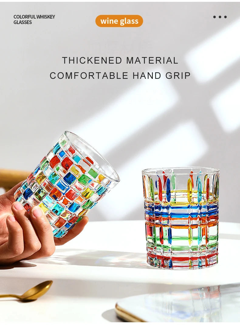 A hand holds a faceted crystal whiskey glass with a thick material and comfortable hand grip, showcasing vintage European des