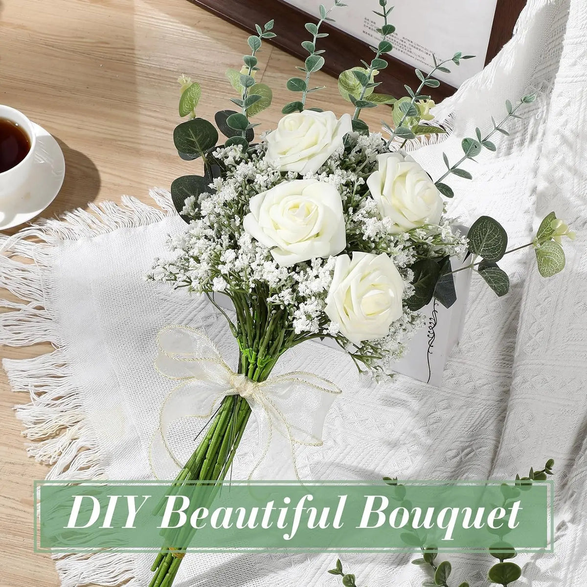 A bouquet of white roses and green eucalyptus with baby's breath stems tied with a sheer ribbon.