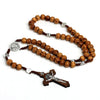 A wooden bead rosary cross necklace featuring natural wood beads and silver accents.