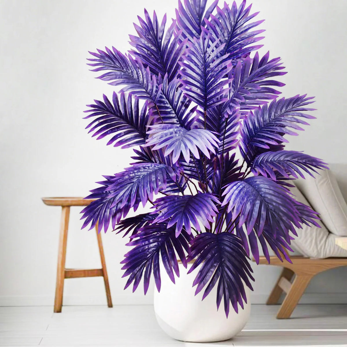 A vibrant purple artificial palm tree with detailed silk leaves displayed in a white pot.