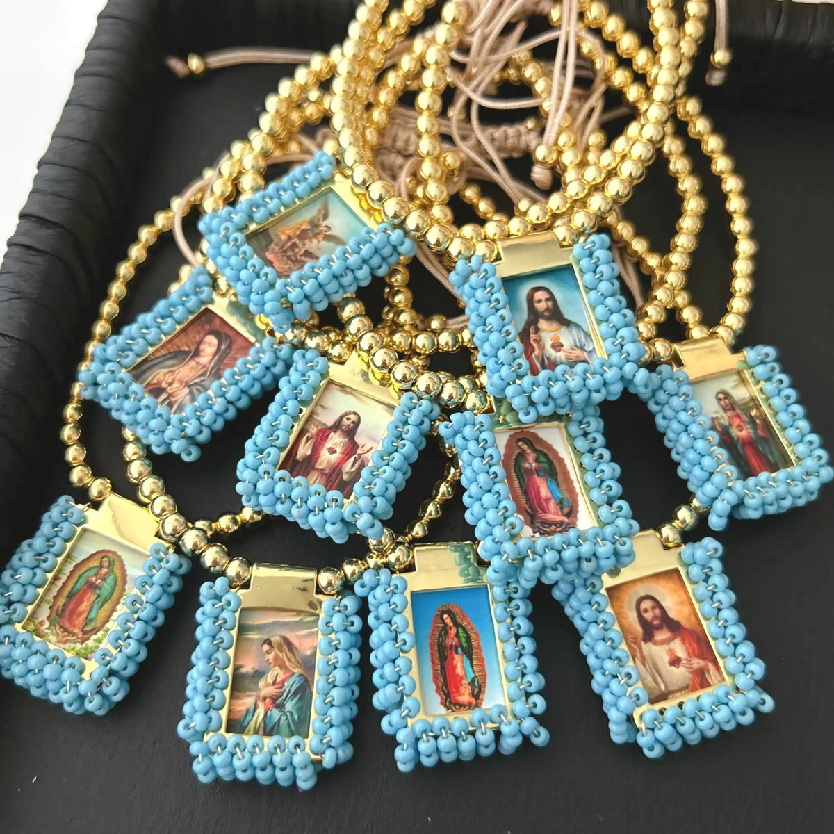 Handmade Virgin Mary Guadalupe gold-plated charm bracelet with blue beads and small framed charms