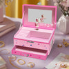 A pink unicorn music jewelry box with a rotating dancer figurine displayed on a purple surface.