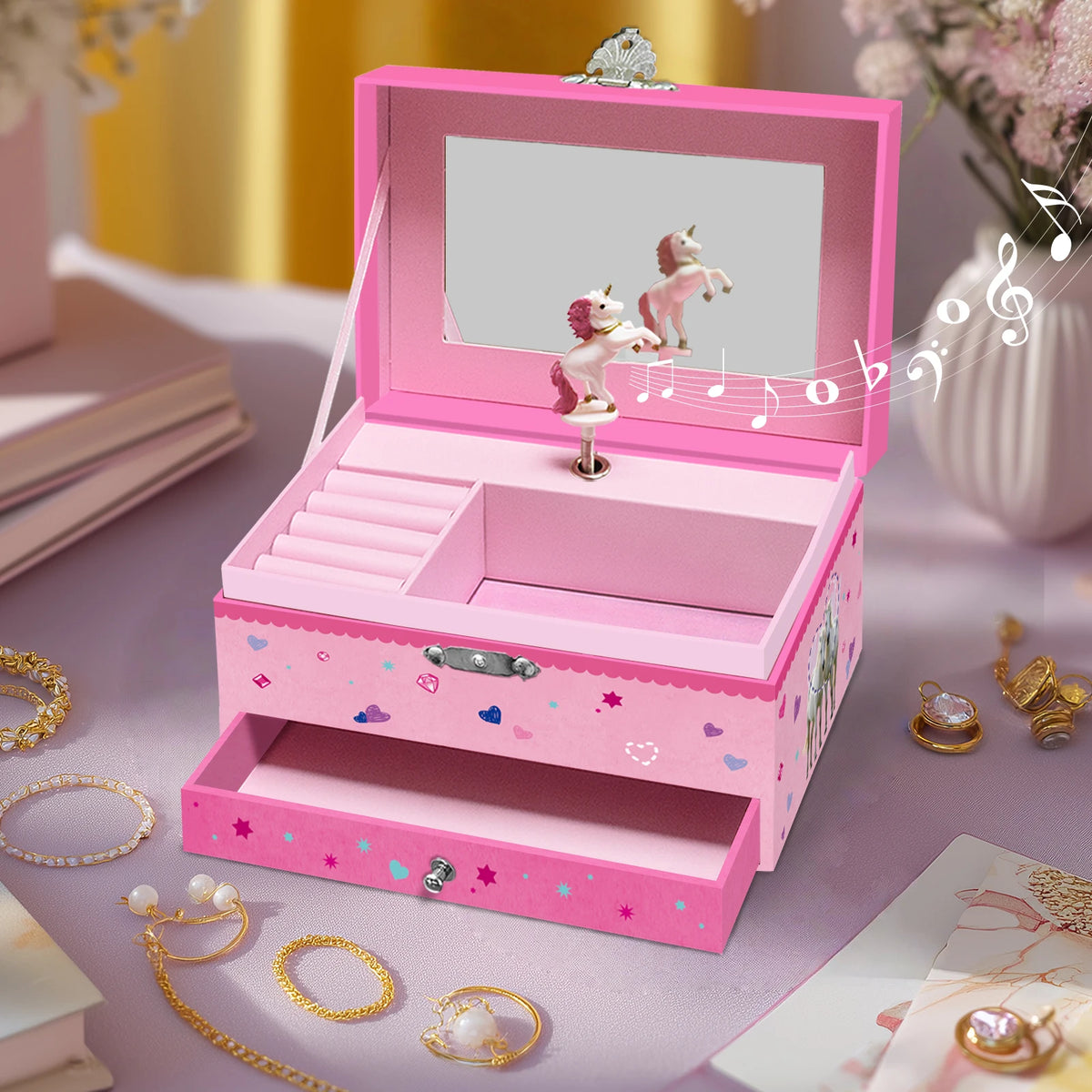A pink unicorn music jewelry box with a rotating dancer figurine displayed on a purple surface.