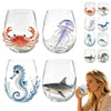 A collection of clear glass wine glasses featuring various ocean themes including a crab, a purple jellyfish, a blue fish, an