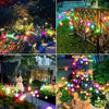 A close-up of a wooden fence illuminated by colorful solar mushroom garden lights in a garden setting.