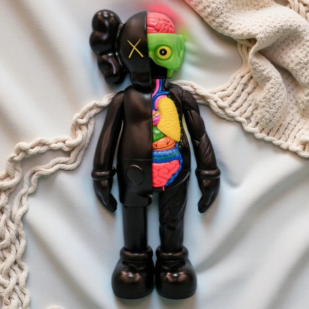 A dark brown bear figurine with a green head and colorful internal anatomy displayed against a white background.