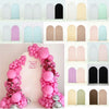 A display of various stretchable arch backdrop covers in shades of pink, green, and black for party and event decor.