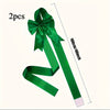 Two green satin ribbon bows measuring 100cm long for decorative purposes