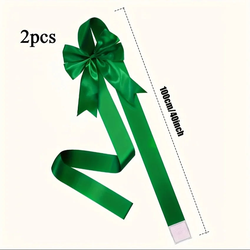 Two green satin ribbon bows measuring 100cm long for decorative purposes