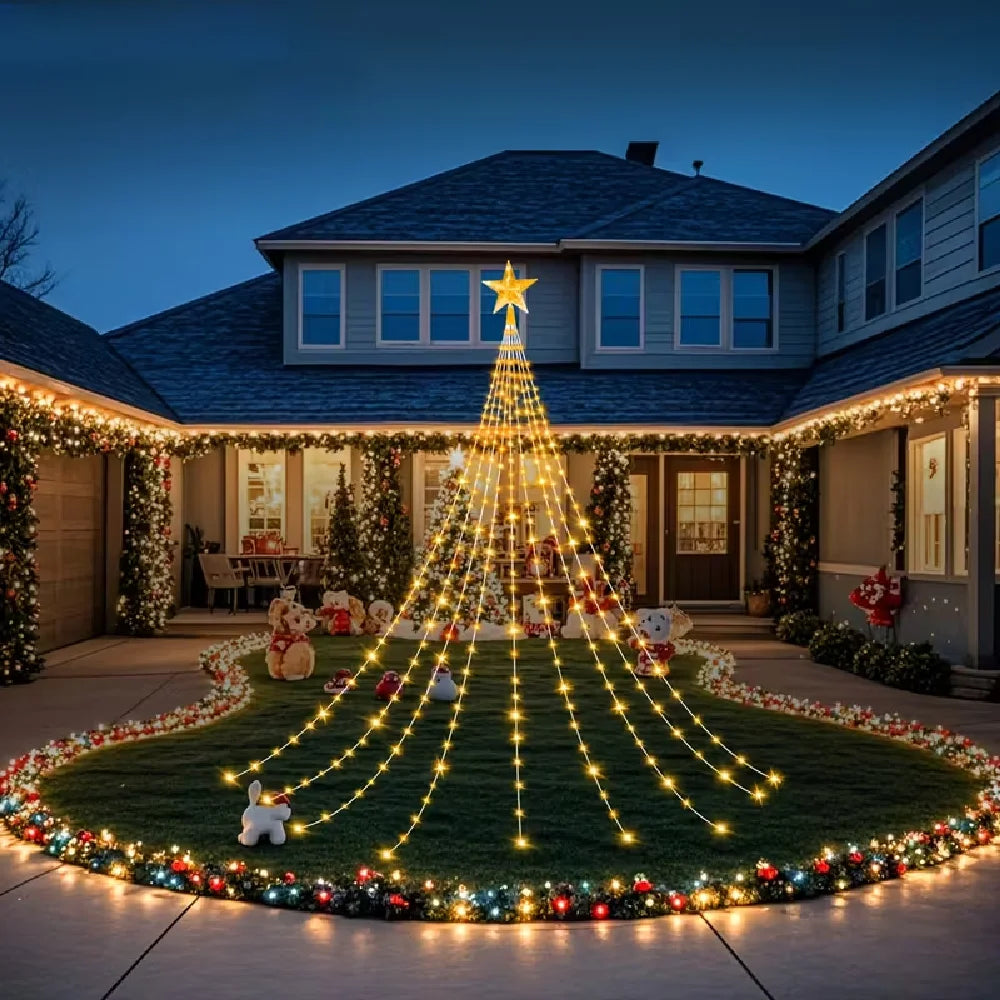 A house decorated with warm yellow string lights shaped like a star on the roof and surrounding landscaping.