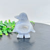 A smooth, translucent gray agate crystal figurine of a bird sitting on a dark surface.
