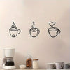 A set of three black line art coffee cup wall decorations displayed on a white wall.