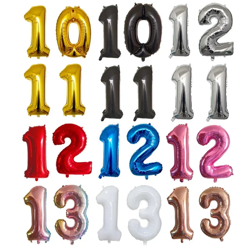 A collection of gold, silver, and black helium foil number balloons for a birthday party.