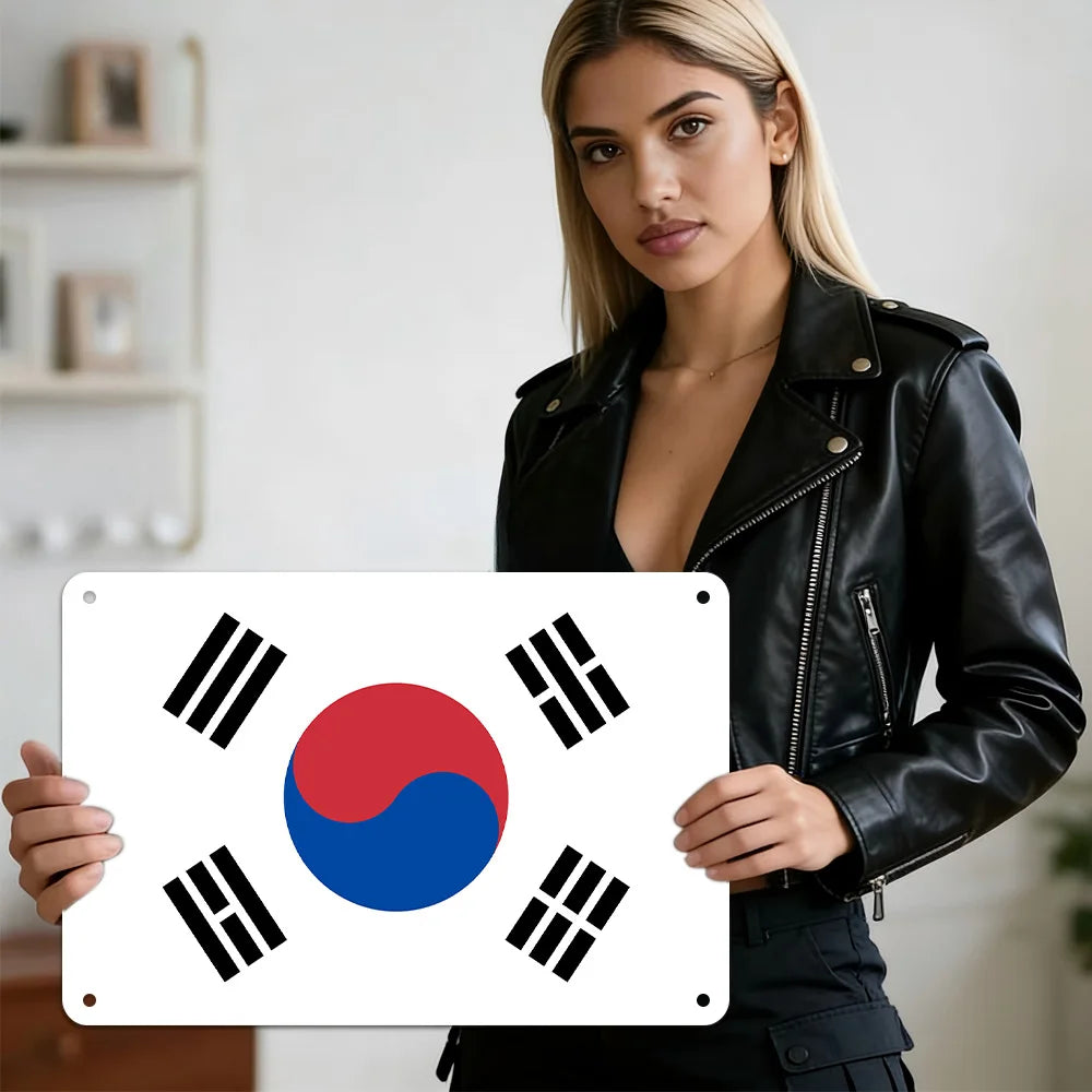 A woman holds a vintage Taegeukgi metal wall plaque against a white background.