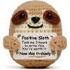 Handmade crochet sloth baseball bat doll with a positivity card