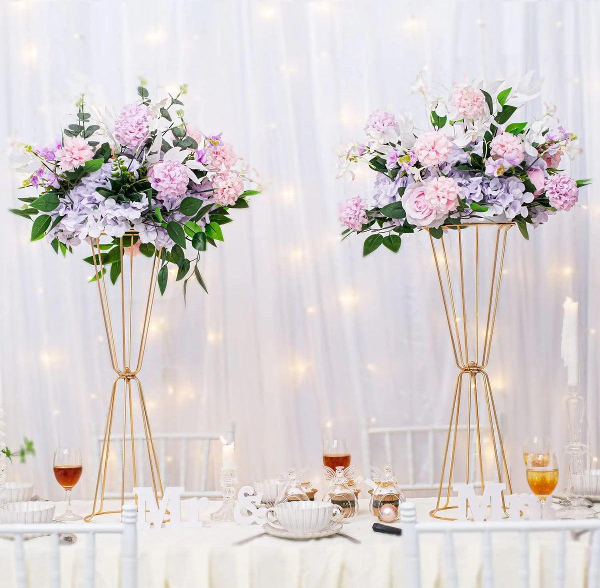 Gold geometric flower stands with pink and purple flowers for table decor