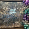 A sparkling silver and blue iridescent sequin wall panel backdrop for a birthday celebration.