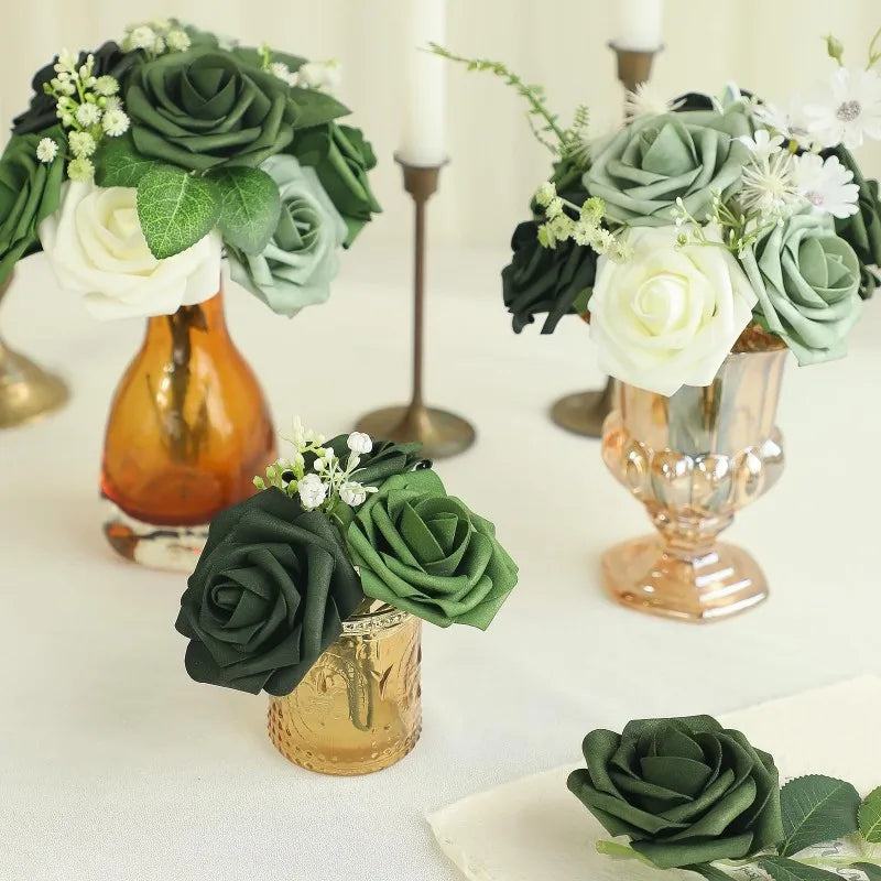 A collection of forest green and white foam roses with stems arranged in various golden vases.